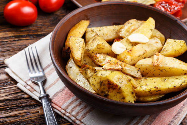 istock baked potatoes with vegetables and herbs on a clay plate. 921714966