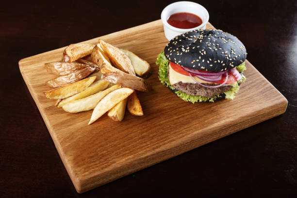 istock black burger with sauce on the board 921715396