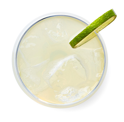 Glass of Classic Daiquiri cocktail with lime isolated on white background. Top view