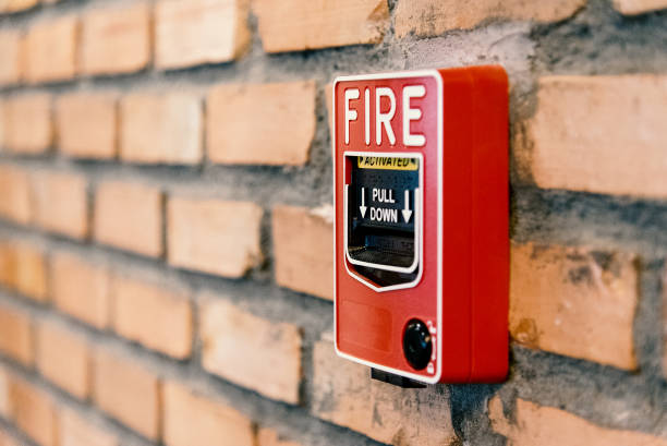 istock Close up fire alarm activation box on brick wall in room 921720254