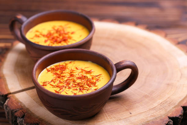 istock Indian turmeric milk with saffron, cardamom and turmeric. Copyspace 921720768