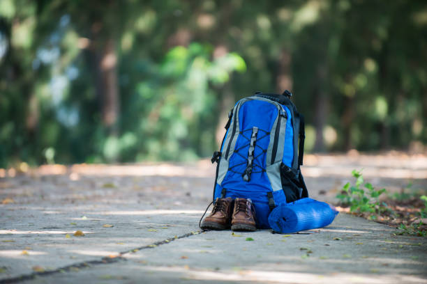 istock Backpack and shoes backpackers rest on the road while go hiking. 921720974