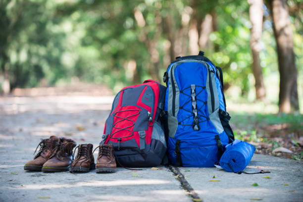 istock Backpack and shoes backpackers rest on the road while go hiking. 921721056
