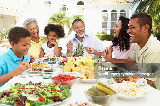 Family Eating An Al Fresco Meal Stock Photo - Download Image Now - African-American Ethnicity, Barbecue - Meal, Family