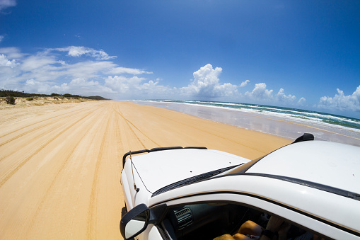 Group of travelers driving a 4x4 and enjoying vacations on Fraser Island, Queensland, Australia