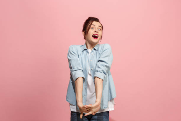 istock Beautiful woman looking suprised isolated on pink 921727214