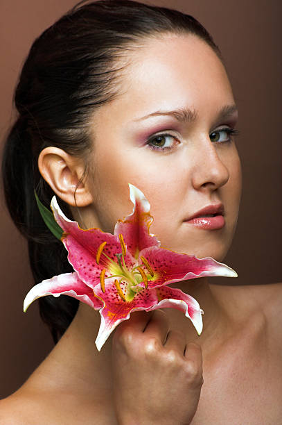 beauty portrait of a woman with lily flower stock photo