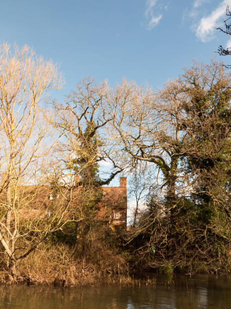 flatford mill house spring from across the lake on side river stour constable country close up flatford mill house spring from across the lake on side river stour constable country close up; essex; england; uk burton sussex stock pictures, royalty-free photos & images