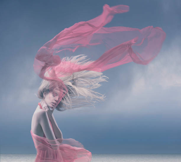 istock fashion model with flutters hair on wind 921732270