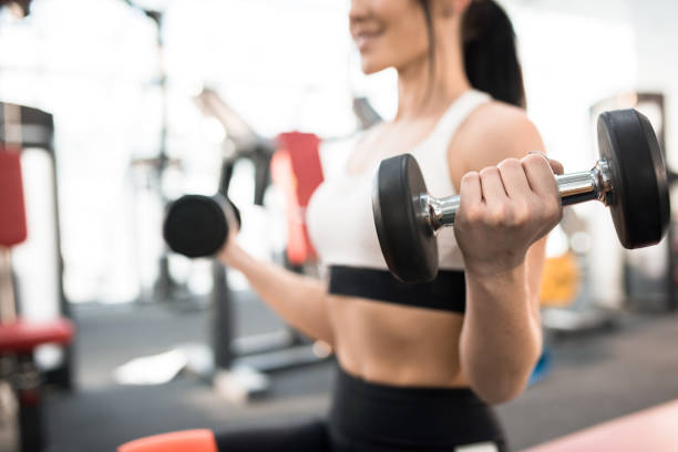 istock Woman Training with Weights in Gym 921732396
