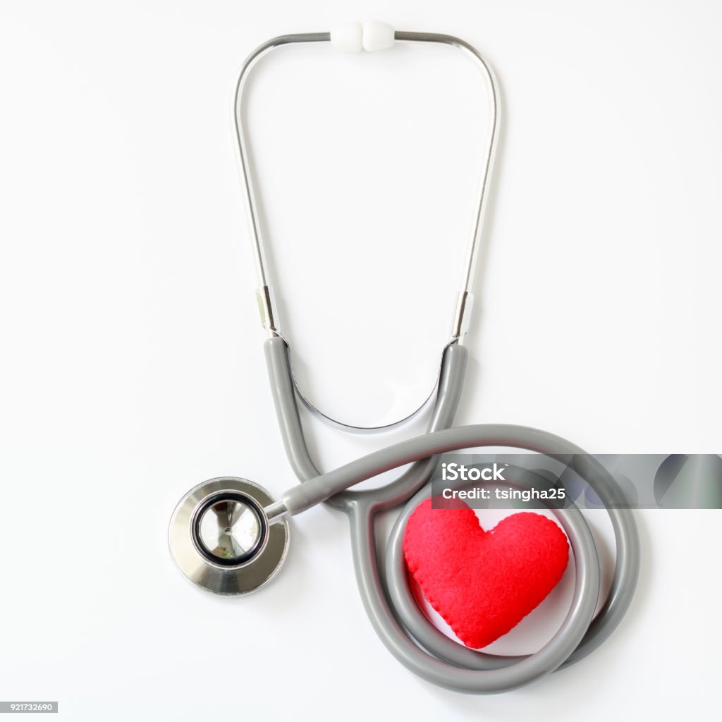 Gray stethoscope with red heart isolated on white background. Medical instruments used to hear sounds within the patient's body. Top view. Heart - Internal Organ Stock Photo