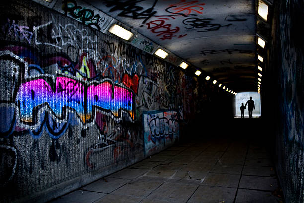Gloomy dark back alley way with exit door at the end.