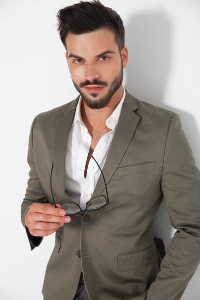istock handsome smart casual man holding glasses 921735830