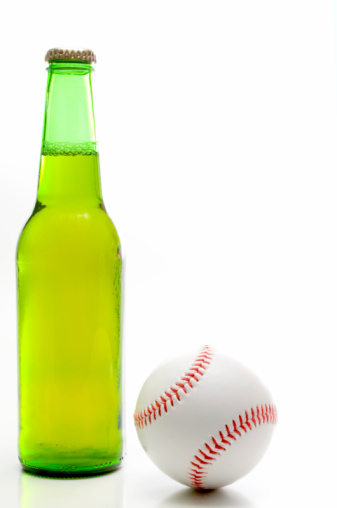 A baseball and a bottle of beer.