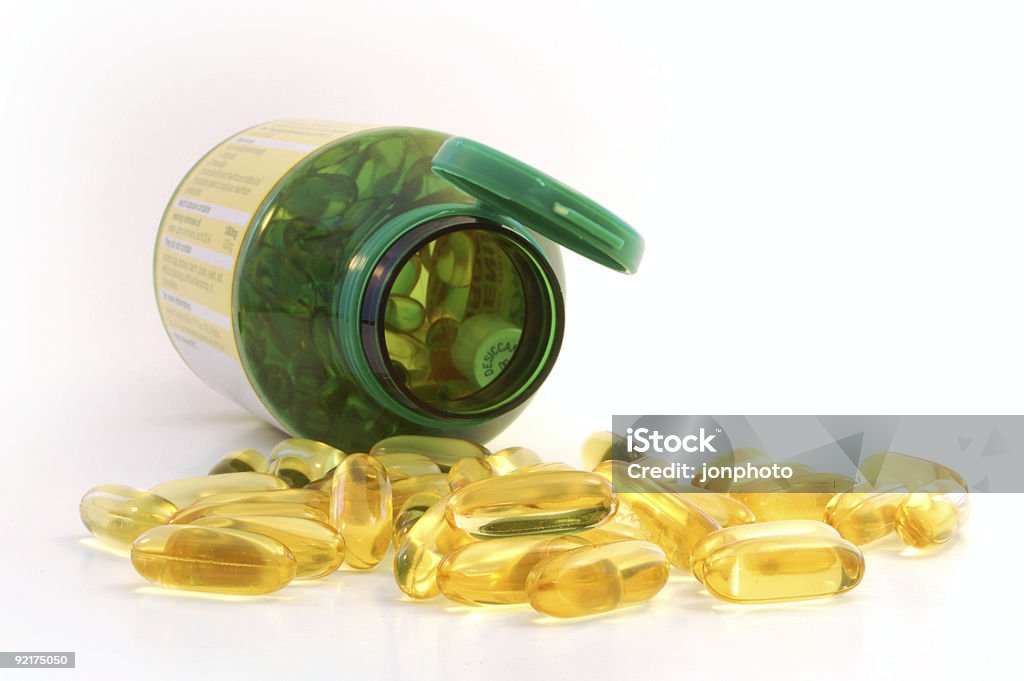 capsules spilling out from the jar  Color Image Stock Photo