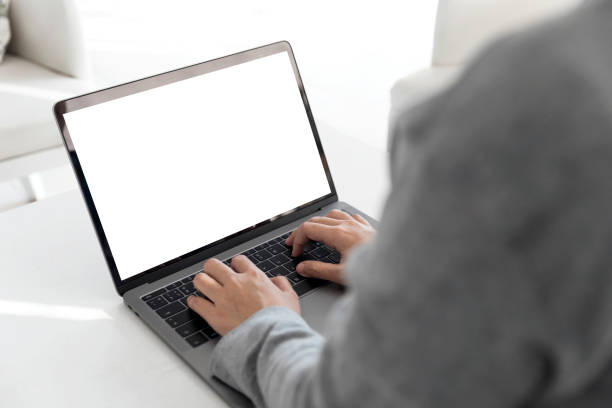 istock Women using laptop with blank screen at table in the office 921758300