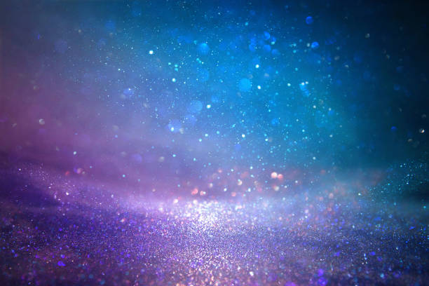 istock glitter vintage lights background. purple, blue and pink. de focused. 921758516