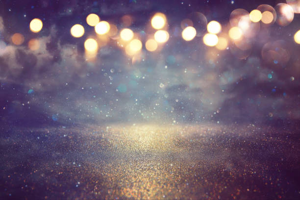 istock glitter vintage lights background. gold and black. de focused. 921758556