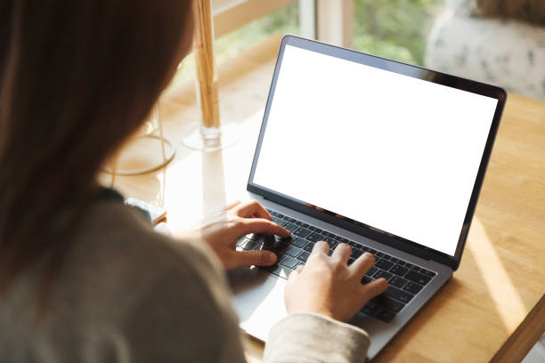 istock Women using laptop with blank screen at table in the office. 921759078