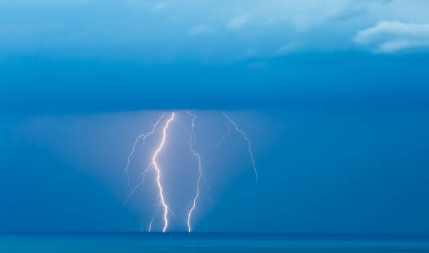 istock Lightning Over Sea Against Blue Sky 921759084
