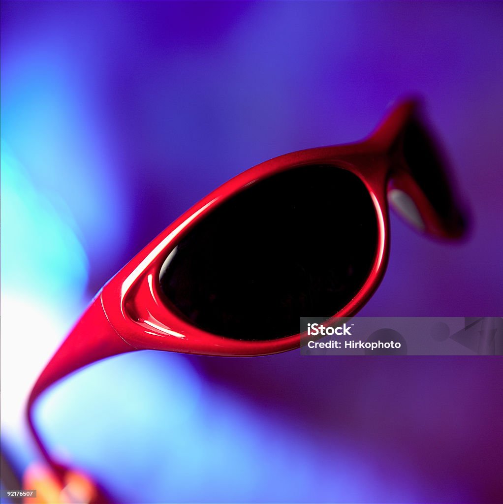 Sun glasses red and blue Red sunglasses on a blue background with selective focus Color Image Stock Photo