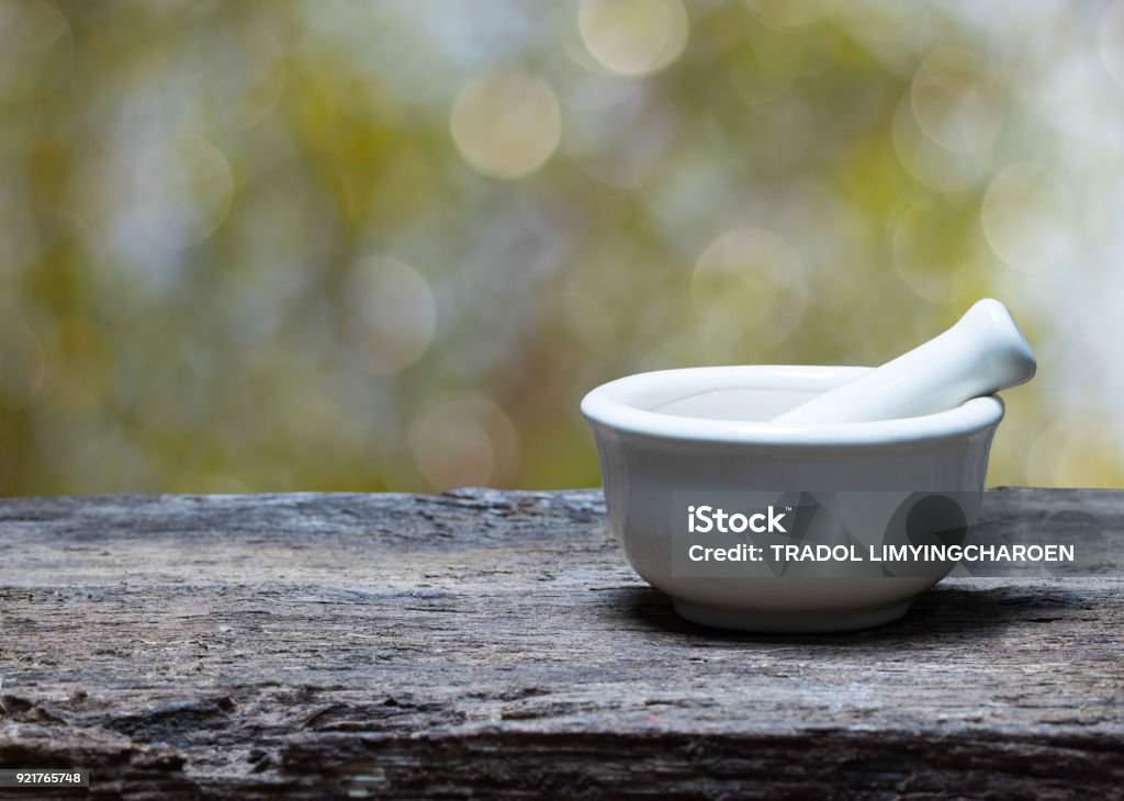 mortar and pestle on wood table Mortar and Pestle Stock Photo