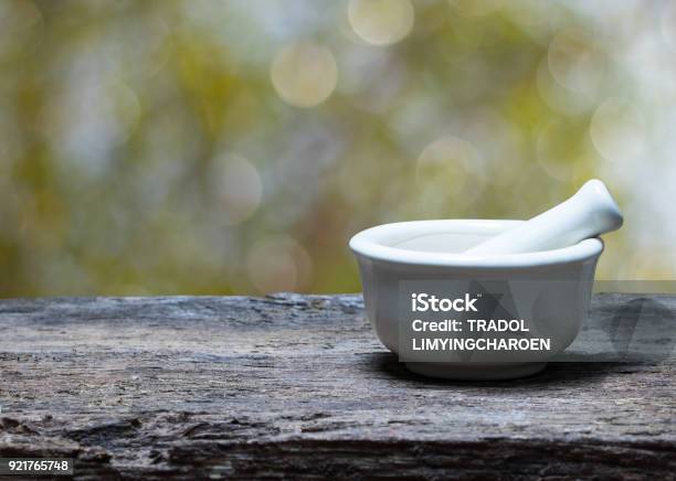 Mortar And Pestle On Wood Table Stock Photo - Download Image Now - Mortar and Pestle, Aromatherapy Diffuser, Beauty