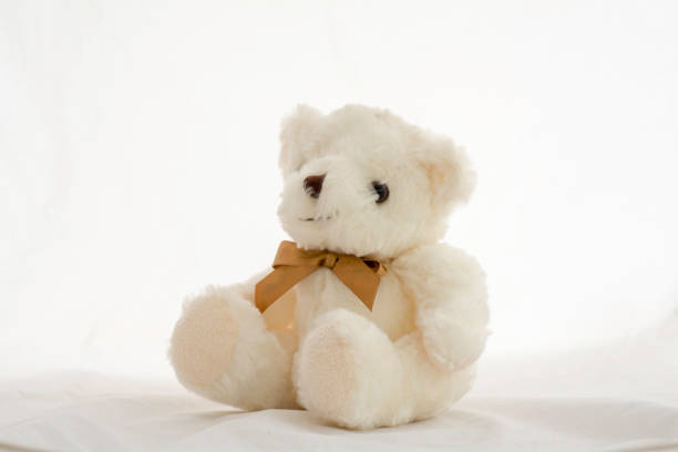 istock soft toy teddy bear  sitting on white background. 921768172