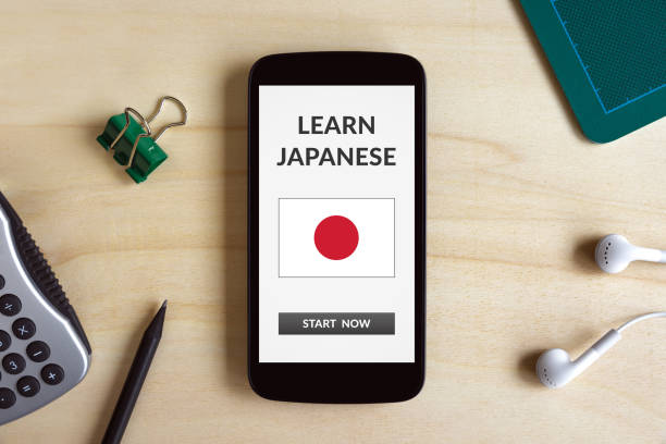 istock Learn Japanese concept on smart phone screen on wooden desk 921770320