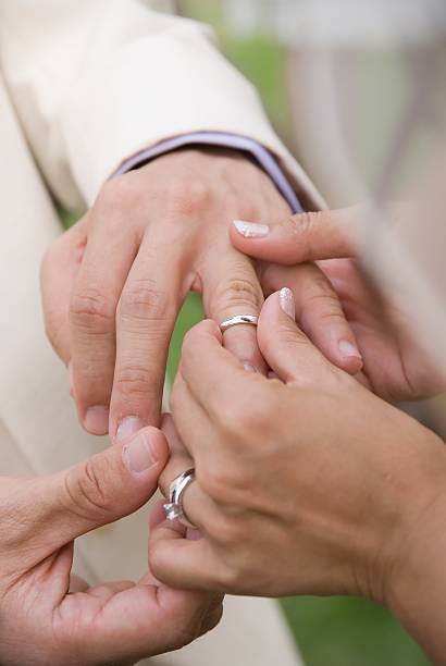 istock Bride putting wedding ring on bridegroom's finger 92177383