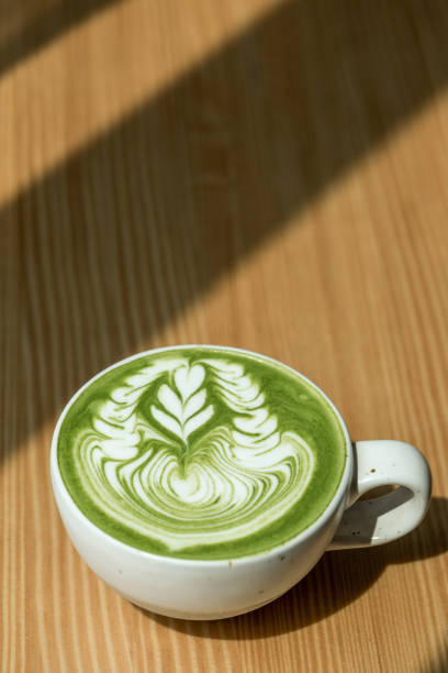 istock close up of Green tea matcha latte with white cup and sunlight 921780312