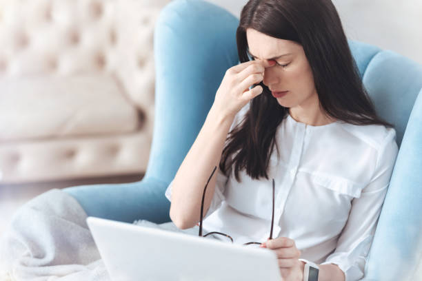 istock Young career woman massaging nose bridge while working 921780698