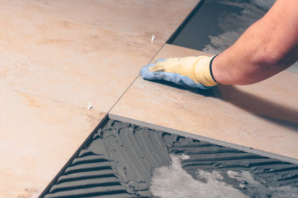 istock The tiler puts the tile on the floor in the classical way 921787890