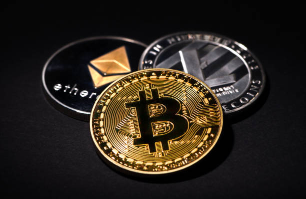 Bitcoin Litecoin Ethereum İstanbul, Turkey - February 19, 2018: Close up shot of Bitcoin, Litecoin and Ethereum memorial coins on a black background. Bitcoin, Litecoin and Ethereum are crypto currencies and worldwide payment systems. litecoin stock pictures, royalty-free photos & images