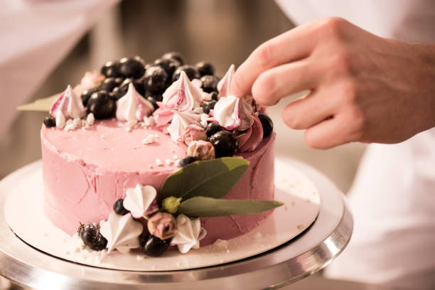 istock partial view of confectioner decorating sweet cake 921788854