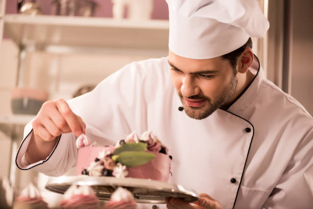 istock portrait of confectioner decorating cake in restaurant kitchen 921788958