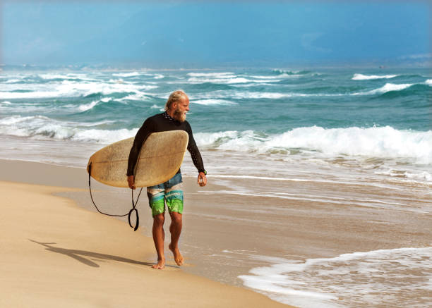 istock Surfer at the sea is standing with a surf board bright color 921789038