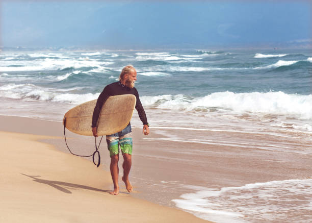 istock Surfer at the sea is standing with a surf board bright color 921789068