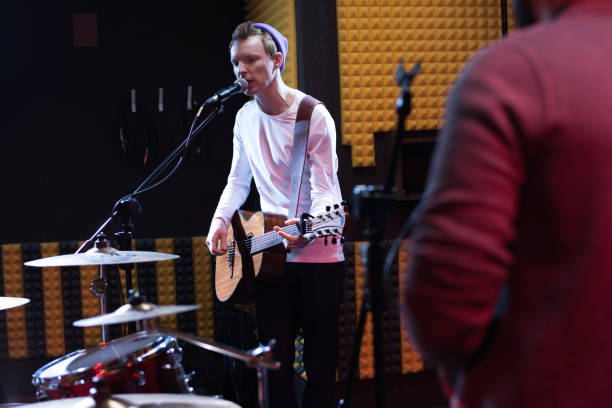 istock Guitarist Singing at Band Rehearsal 921789534