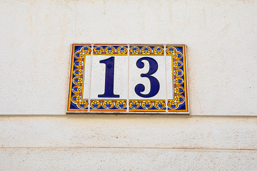 Patterned ceramic tiles portraying the number 13.