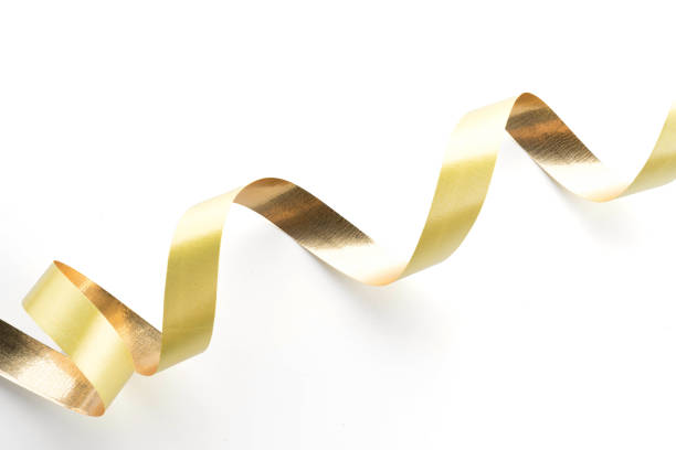 istock Golden ribbon roll isolated on white background 921789730