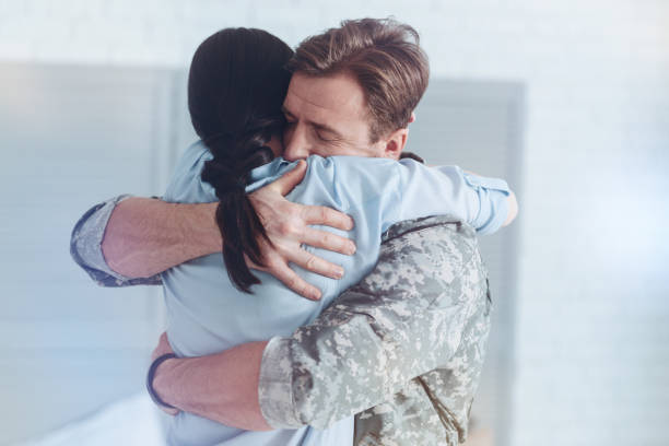 istock Sad woman and military husband embracing at parting 921796270