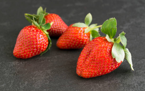 istock Ripe juicy strawberries on a gray background. 921797718