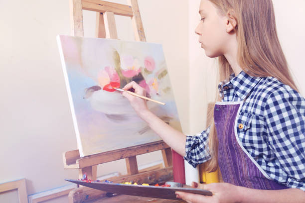 istock Serious teenage girl creating new masterpiece during workshop 921802144