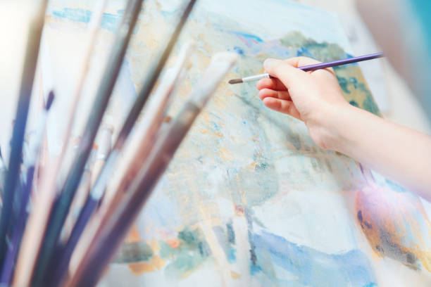 istock Scaled up look on young painter working on abstract picture 921808228