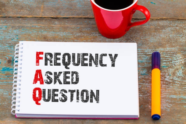 istock Notebook, pen and a cup of coffee on wooden table. Notebook written FAQ - Frequency Asked Question, business concept 921814176