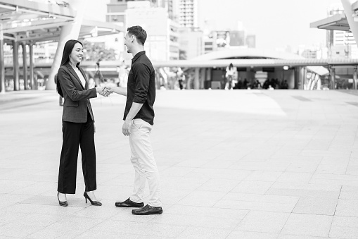 Image processing black and white color, Businessman and woman shake hands. concept of friend welcome, introduction, product advertisement, partnership approval and strike bargain on deal.