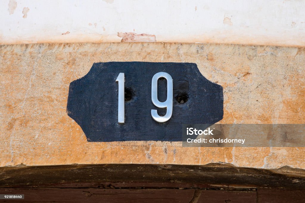 Number 19 The number 19 on a wall. Antique Stock Photo