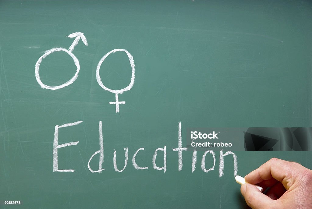 Hand writing chalk on blackboard titled about Sex Education A chalkboard represention sex education in school. Sex Education Stock Photo