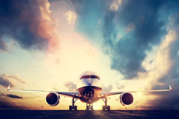 istock Passenger airplane taking off on runway at sunset 921828564